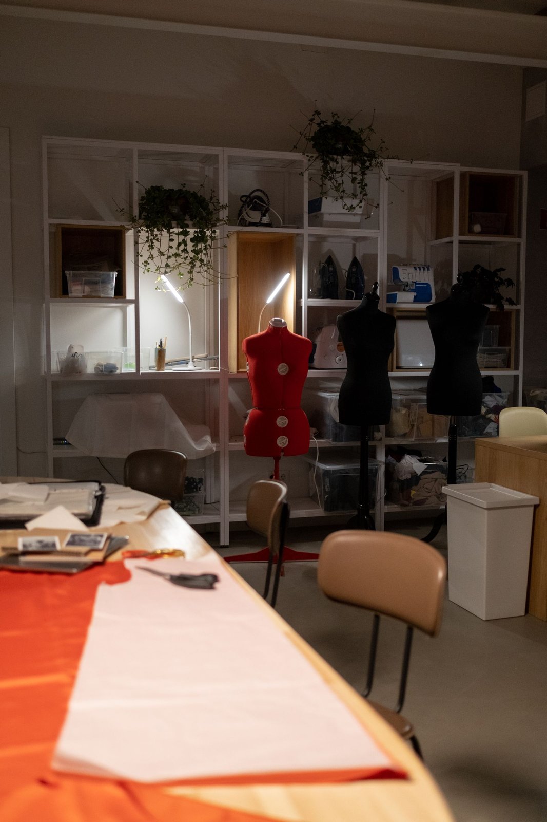 The atelier — workstations, mannequins, and natural light.