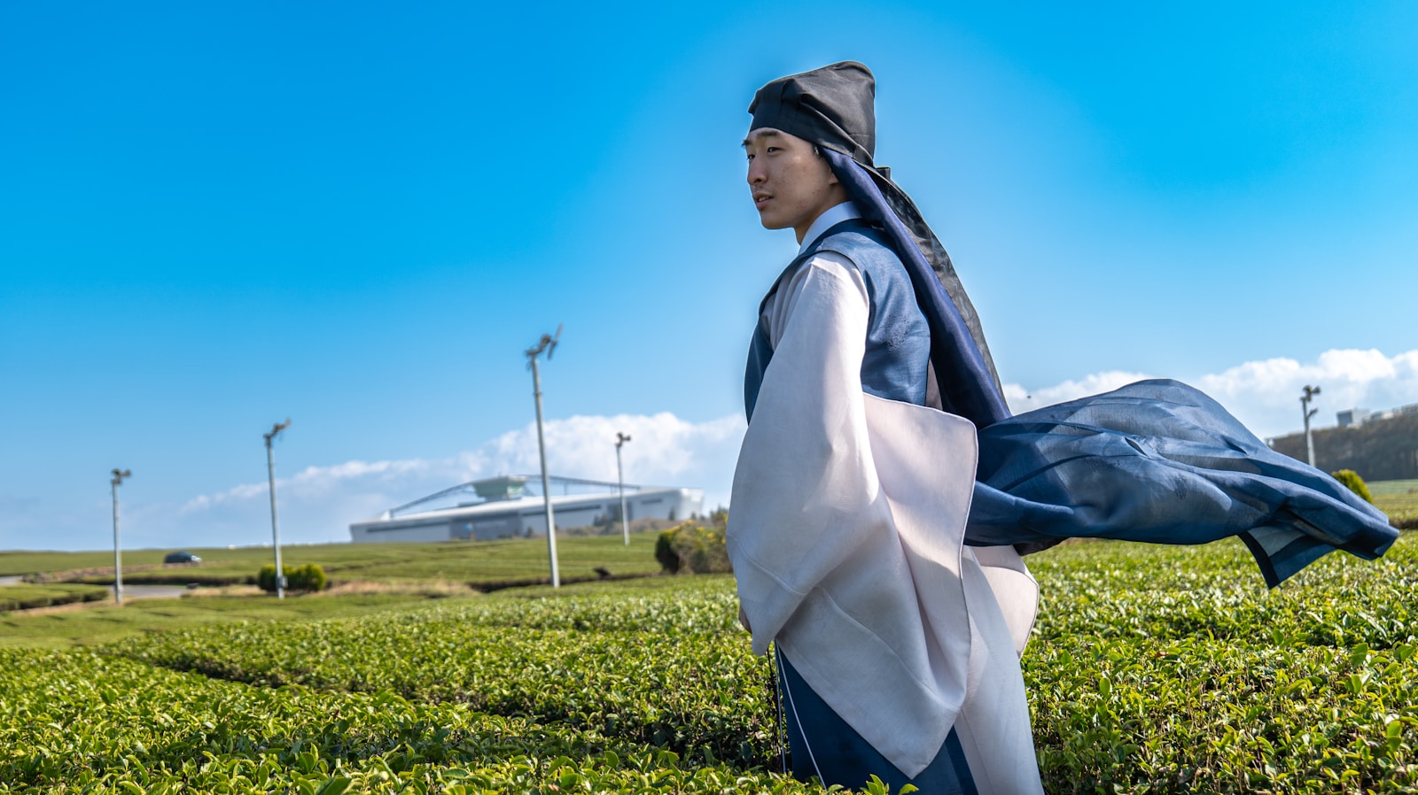a man in a kimono walking through a field